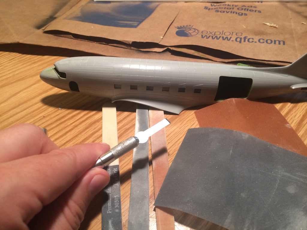 Tools of the procedure: chisel blade, sanding sticks and papers